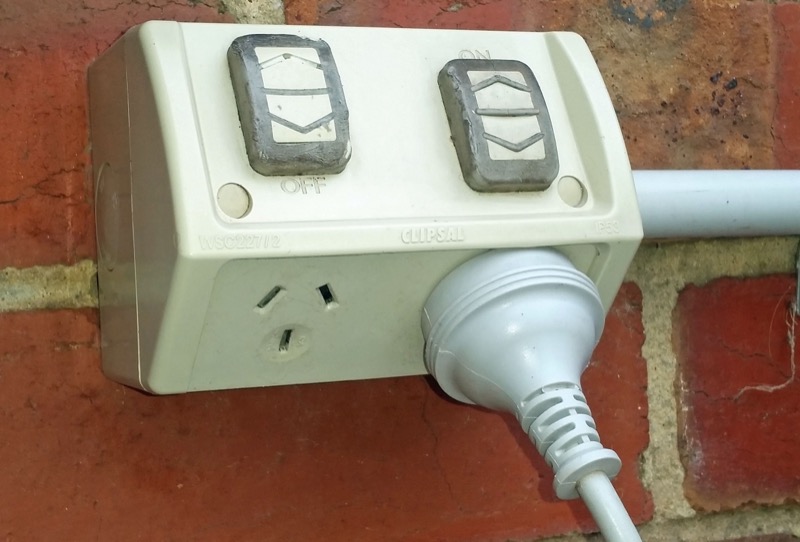 Clipsal weatherproof outdoor Australian power point mounted on brick wall